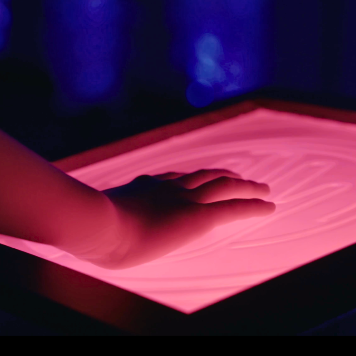 A guest interacting with a responsive FUSION light installation