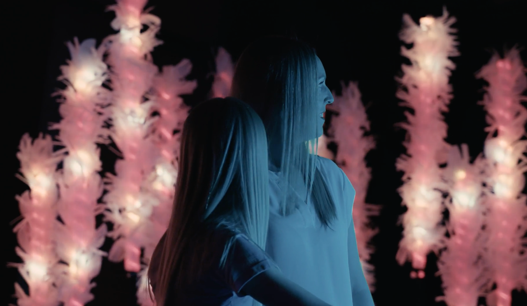 Two visitors surrounded by illuminated elements